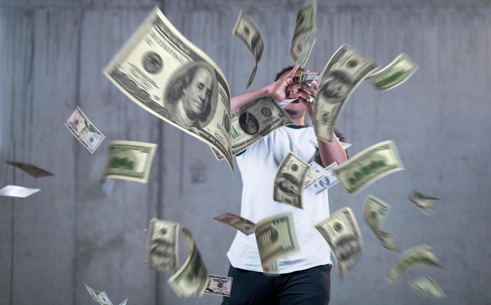 black businessman making the rain of money photo
