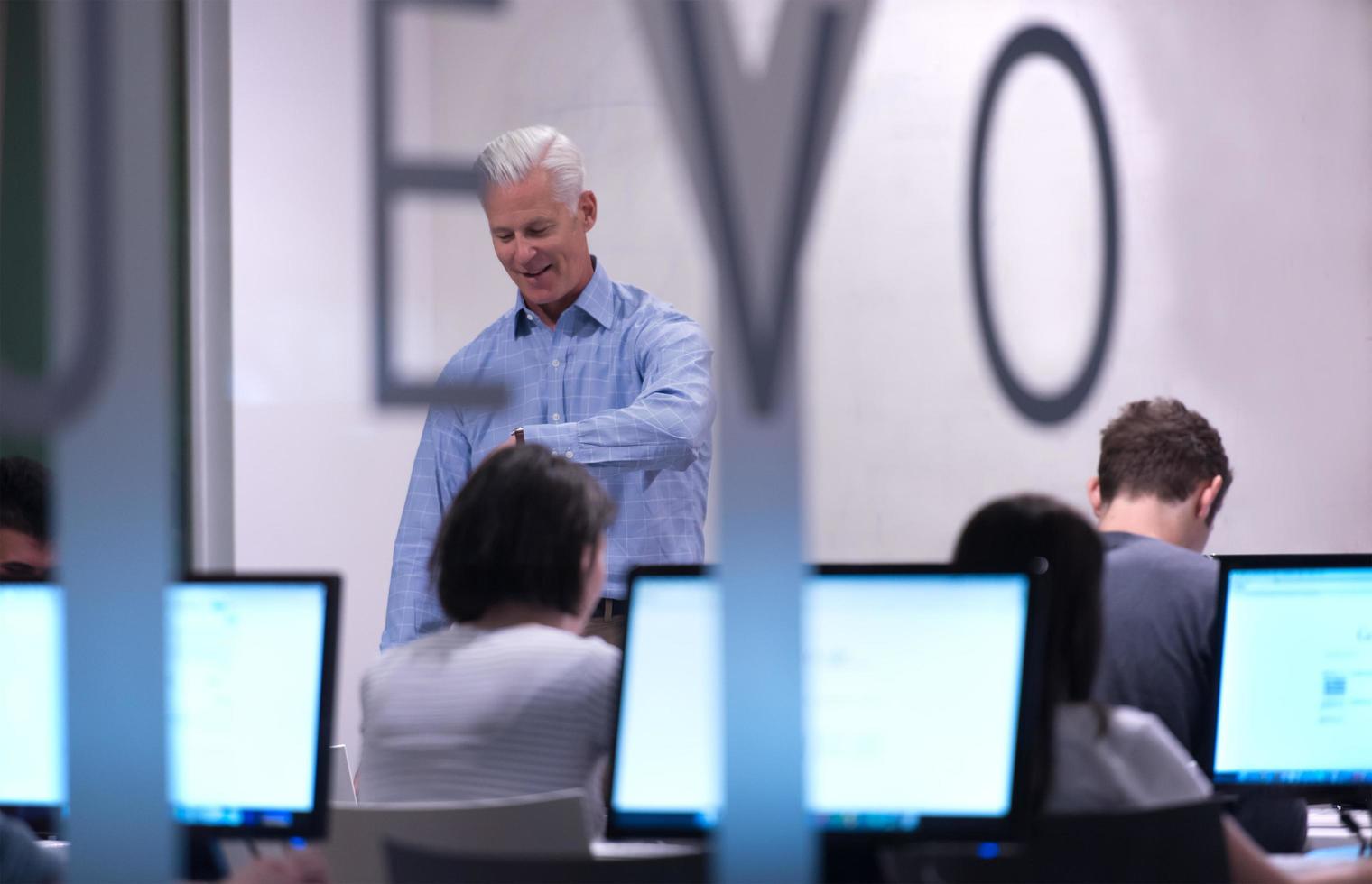 teacher and students in computer lab classroom photo