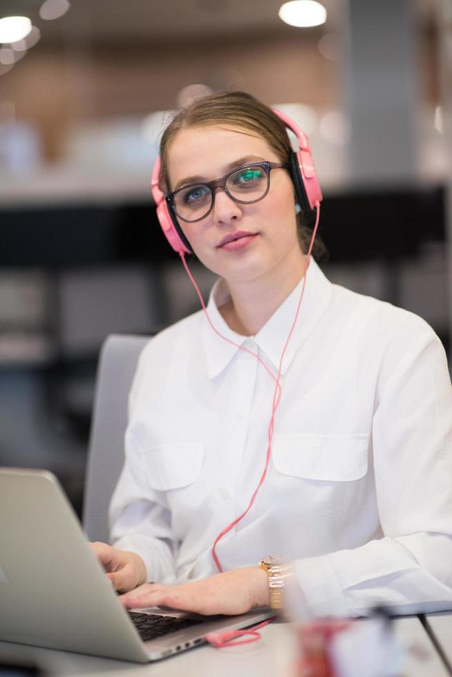 businesswoman using a laptop in startup office photo