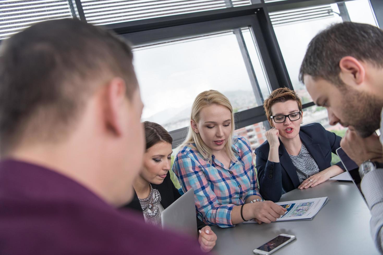 Group of young people meeting in startup office photo