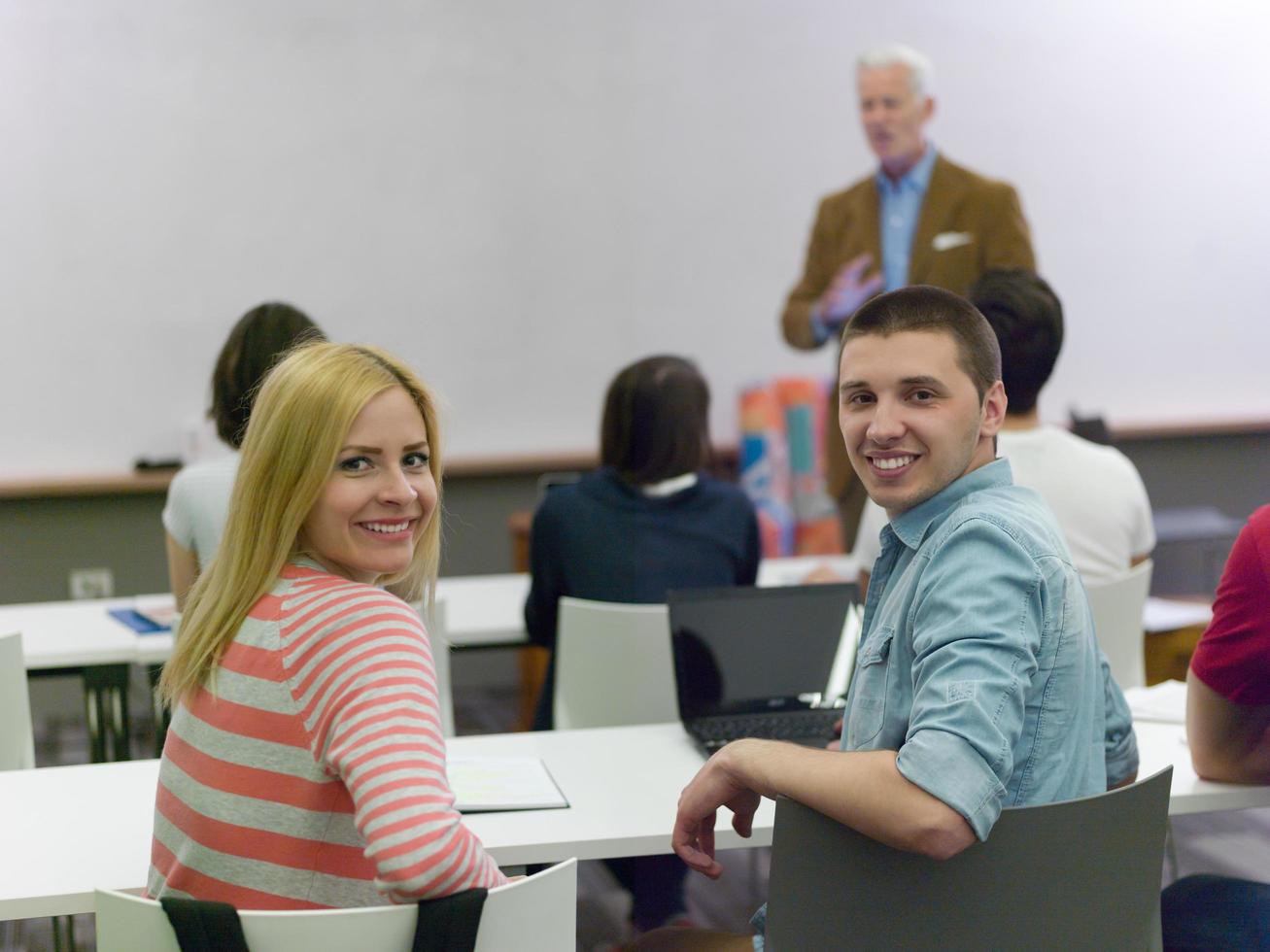 teacher with a group of students in classroom photo
