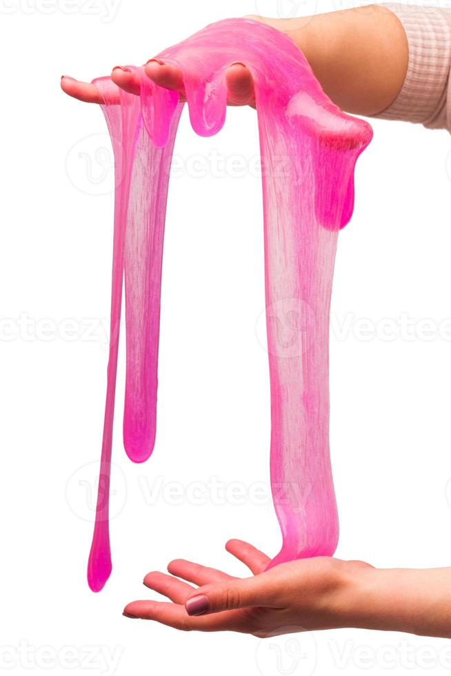 a toy for children mucus and liquid flowing on hand on a white background photo