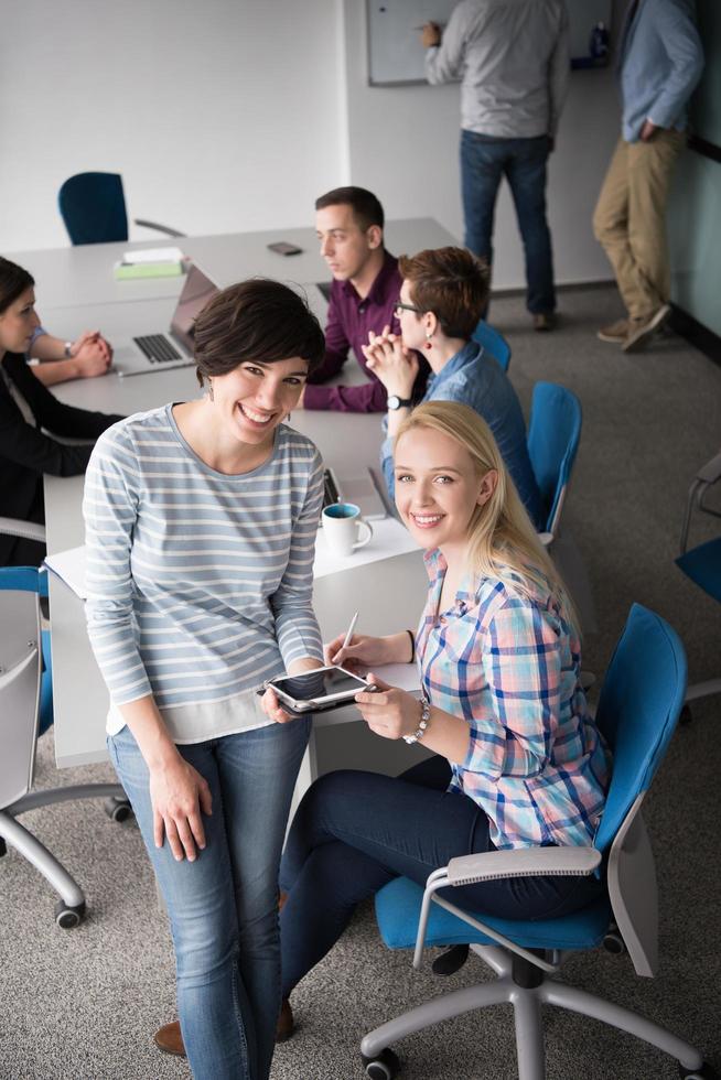 Pretty Businesswomen Using Tablet In Office Building during conference photo
