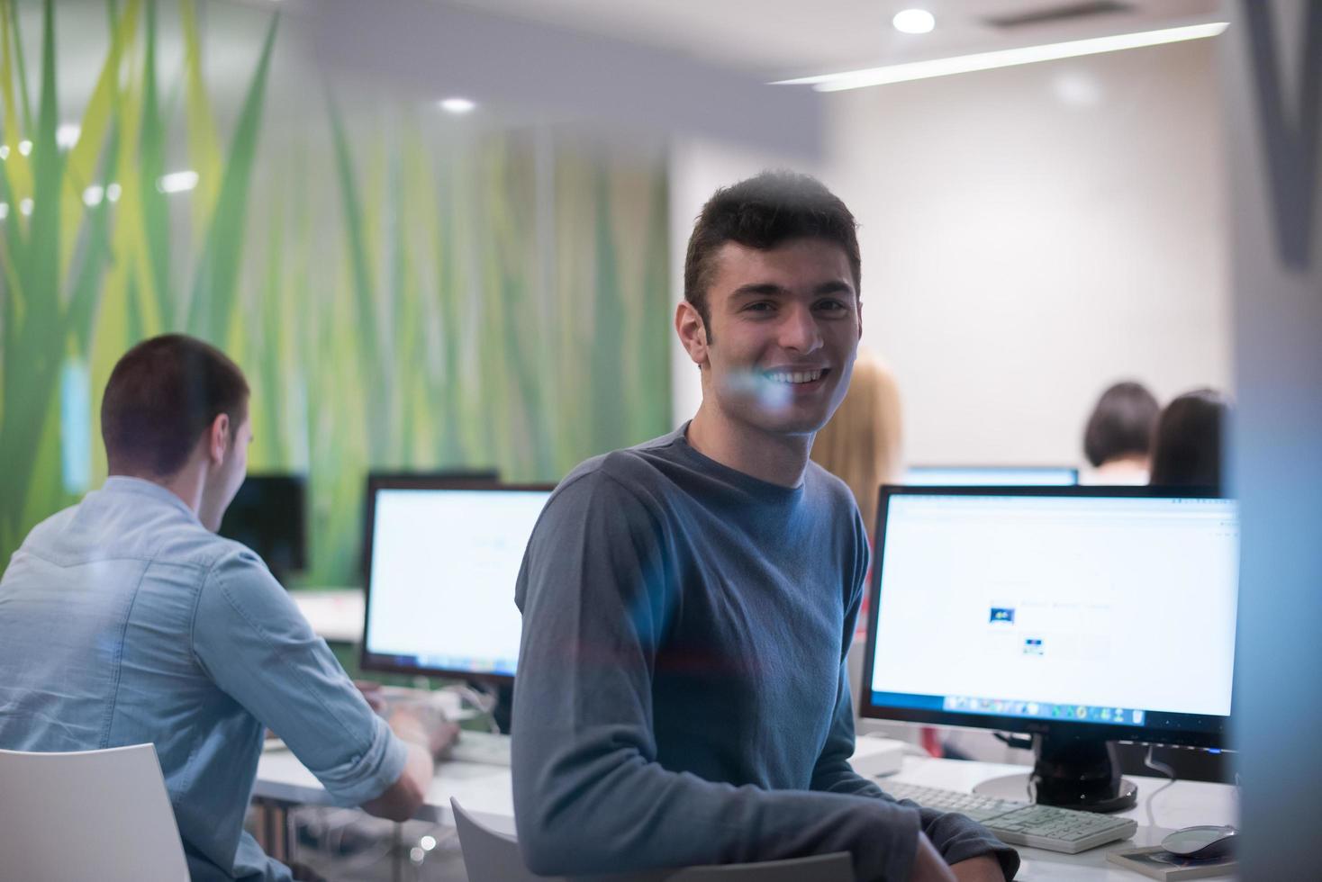 technology students group working  in computer lab school  classroom photo