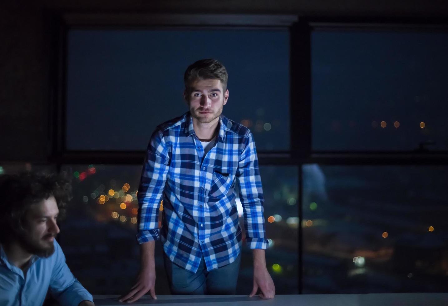 business people on construction site  in new startup office at night photo