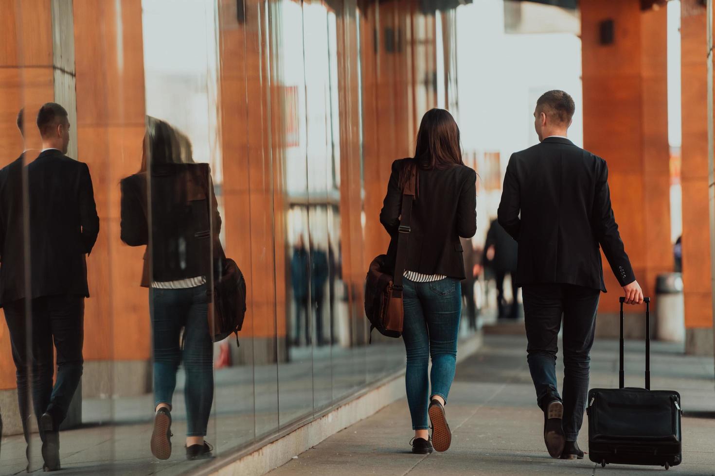 Business man and business woman talking and holding luggage traveling on a business trip photo