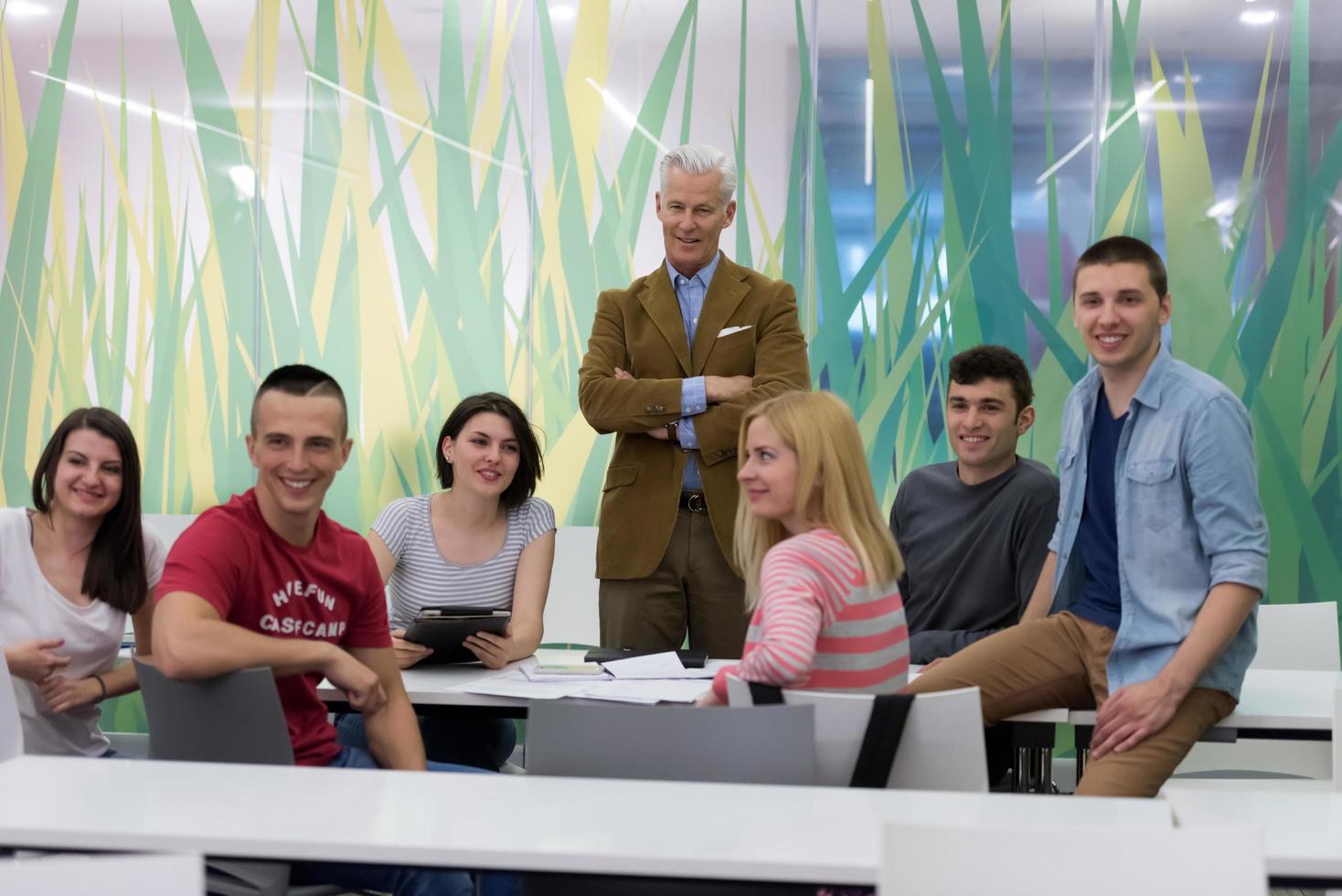portrait of  teacher with students group in background photo