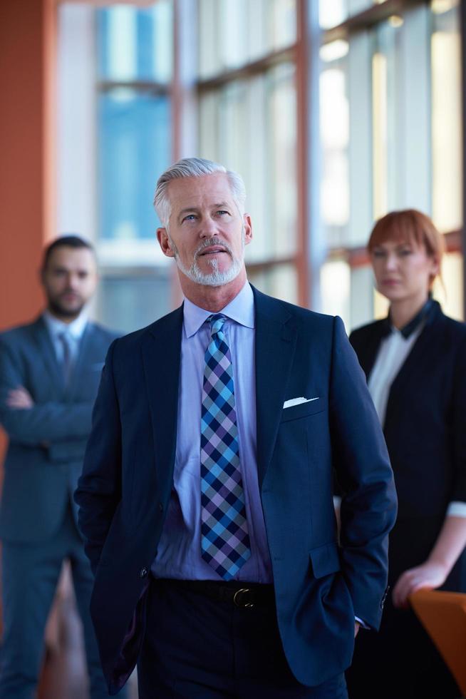 senior business man with his team at office photo