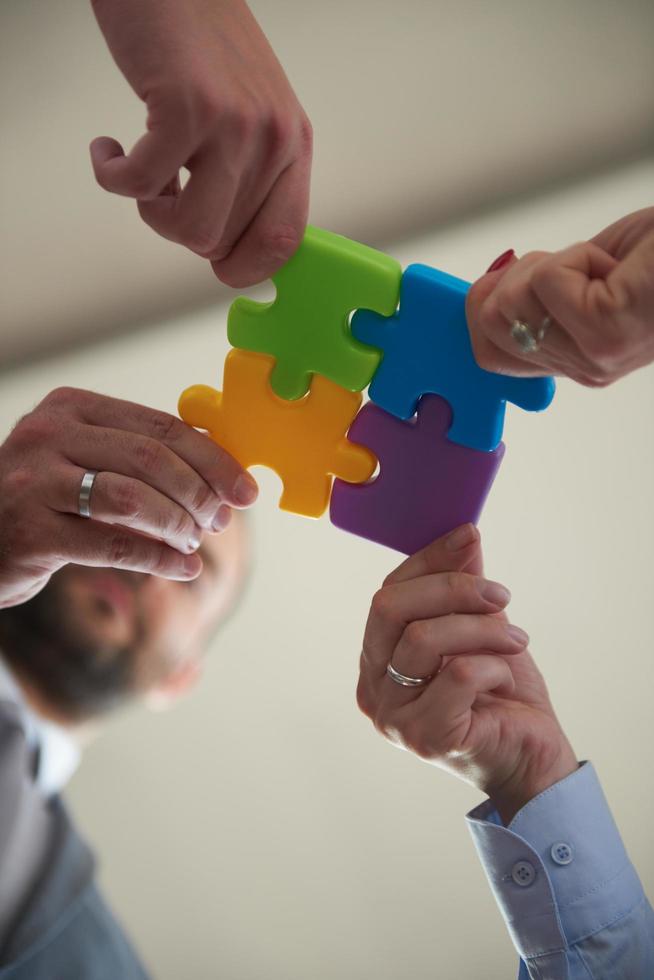 business people group assembling jigsaw puzzle photo