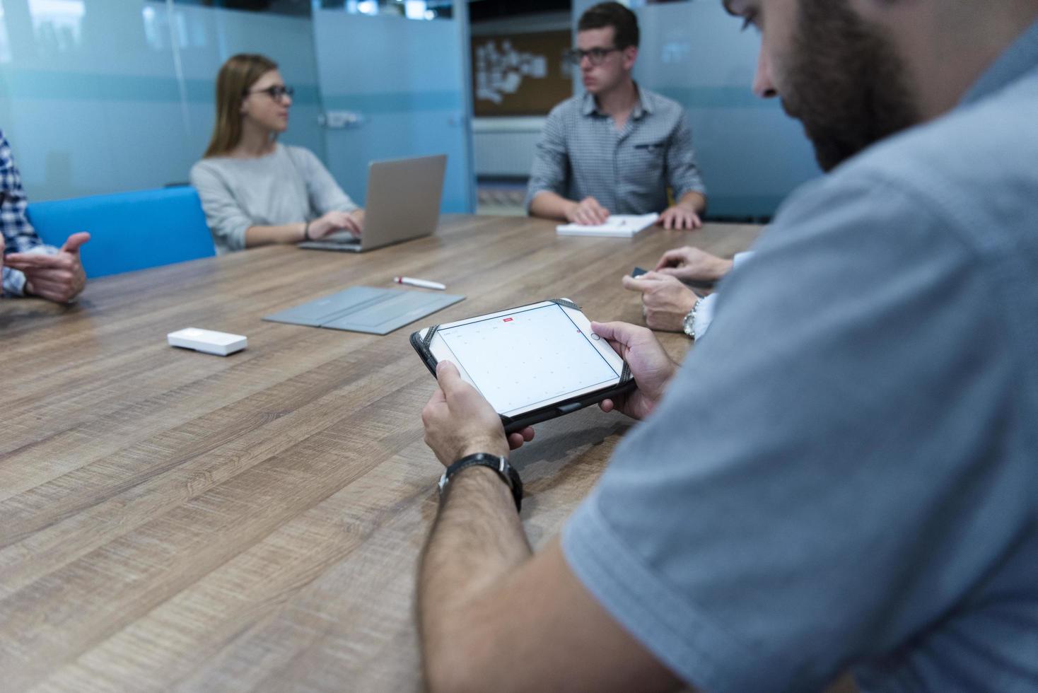 close up of businessman on meeting using tablet photo