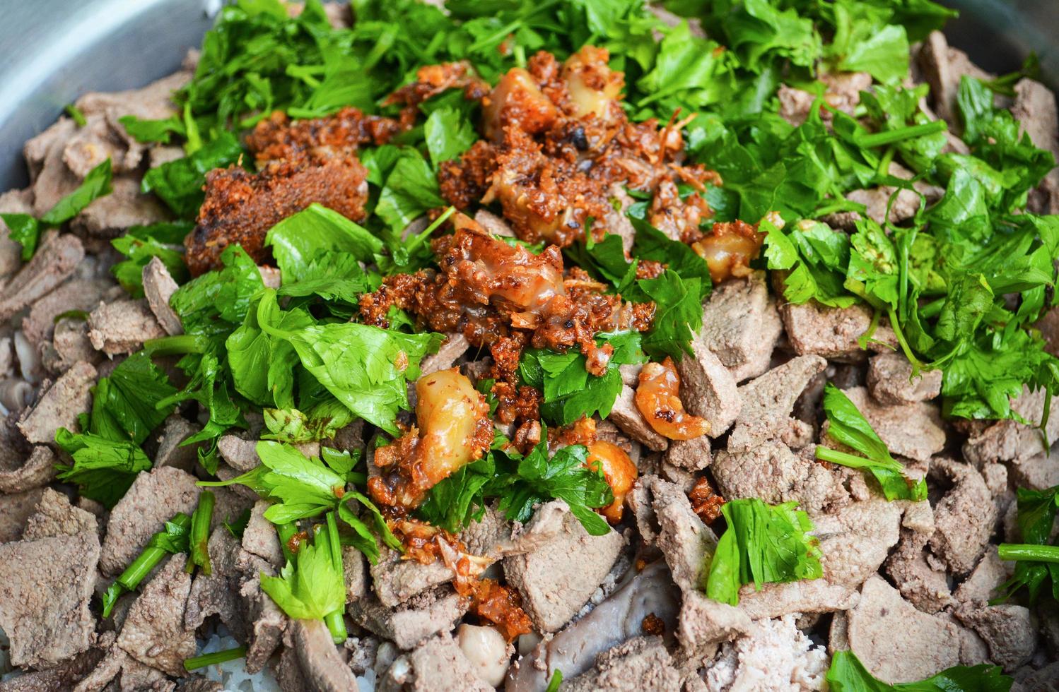 cooking of pork liver pig slice with celery vegetable and deep fried garlic photo