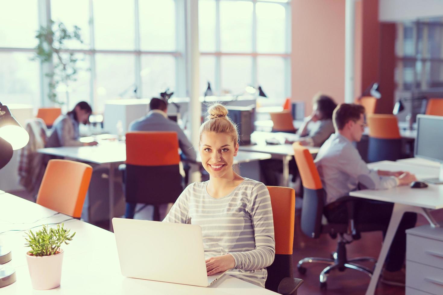 businesswoman using a laptop in startup office photo