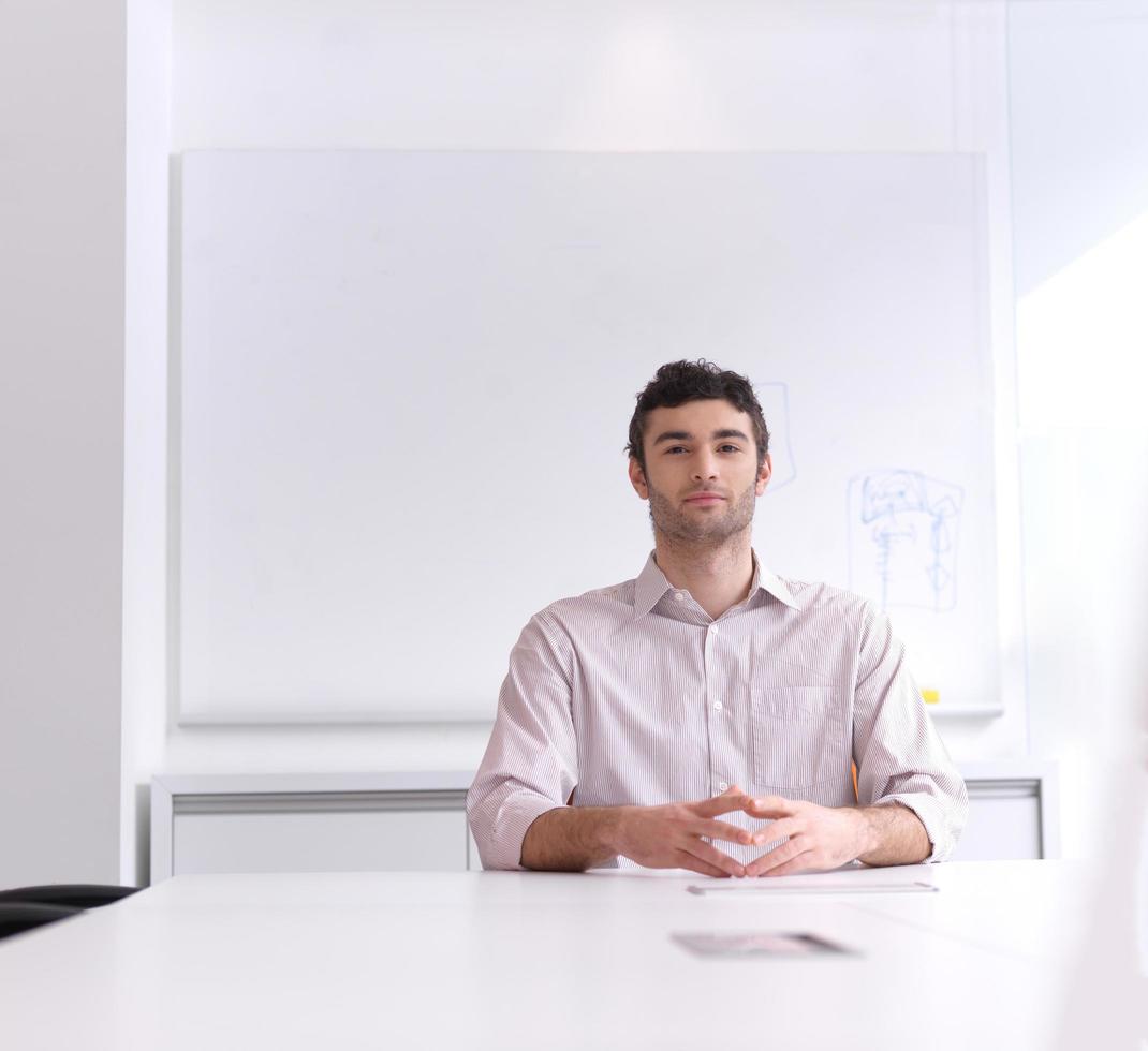 young business man portrait  at modern office photo