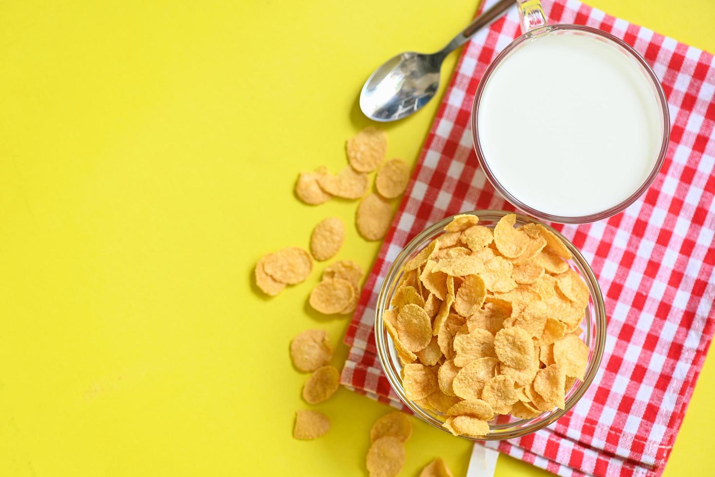 cornflakes bowl breakfast food and snack for healthy food concept, morning breakfast fresh whole grain cereal, cornflakes with milk on yellow background photo