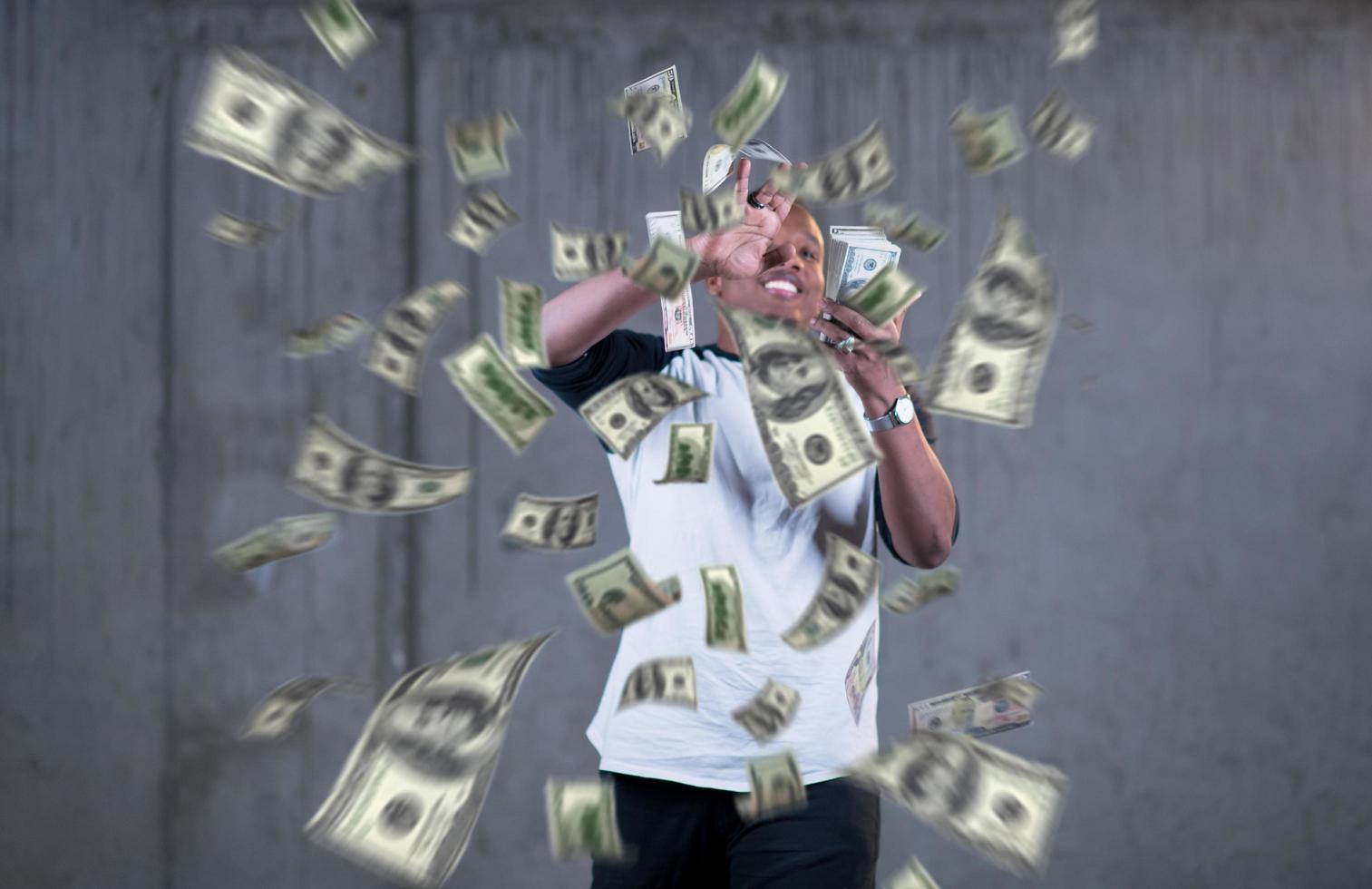 black businessman making the rain of money photo