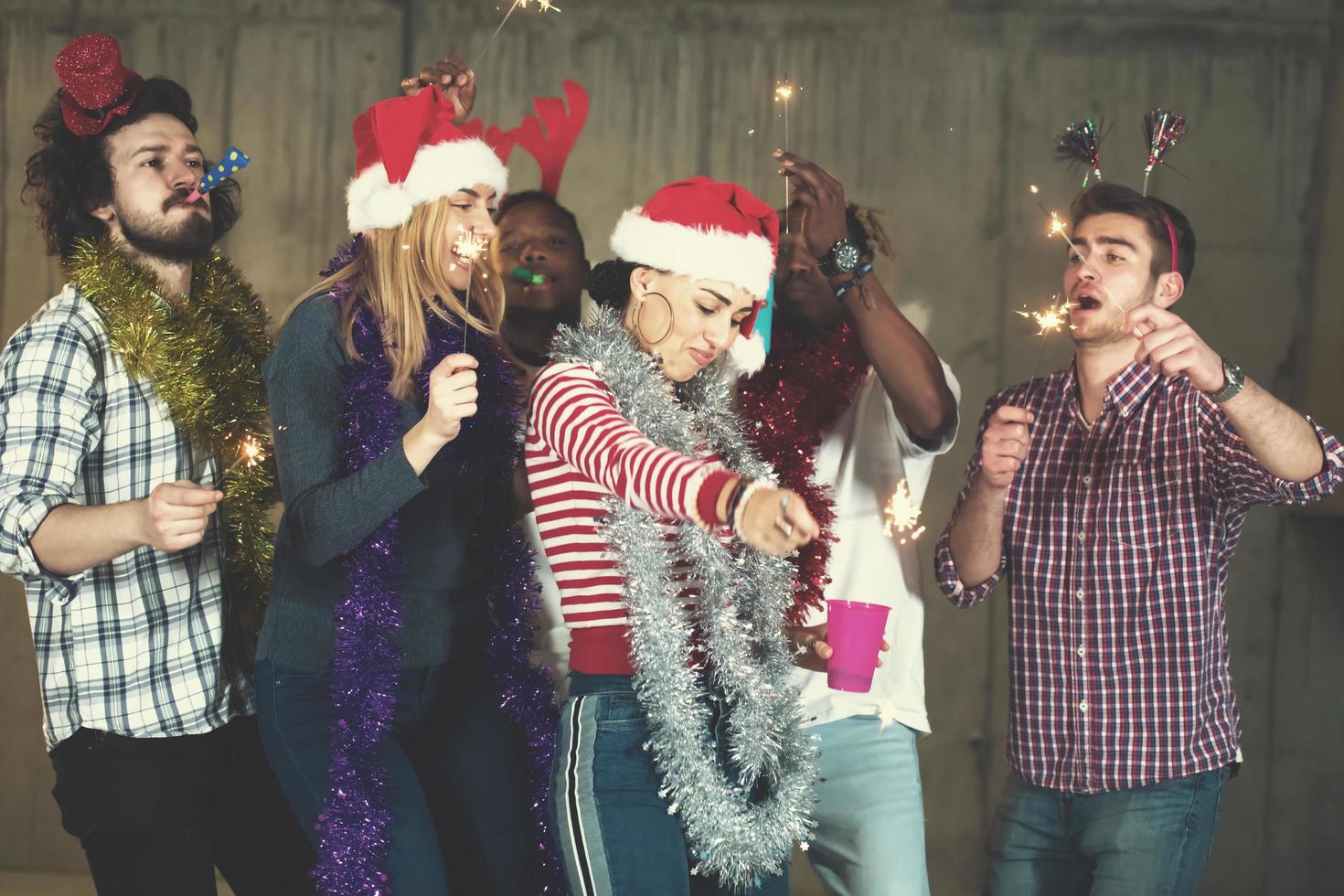 multiethnic group of casual business people dancing with sparklers photo