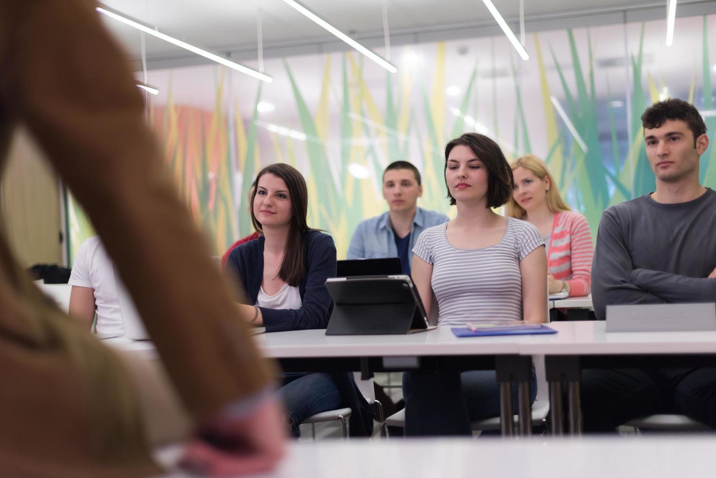teacher with a group of students in classroom photo