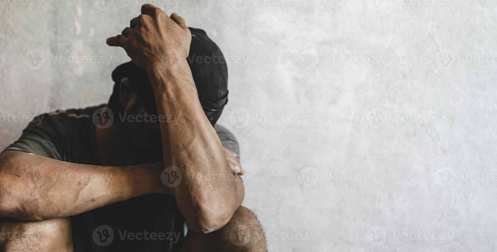 Homeless man drug and alcohol addict sitting alone and depressed  feeling anxious and lonely, social documentary concept. photo