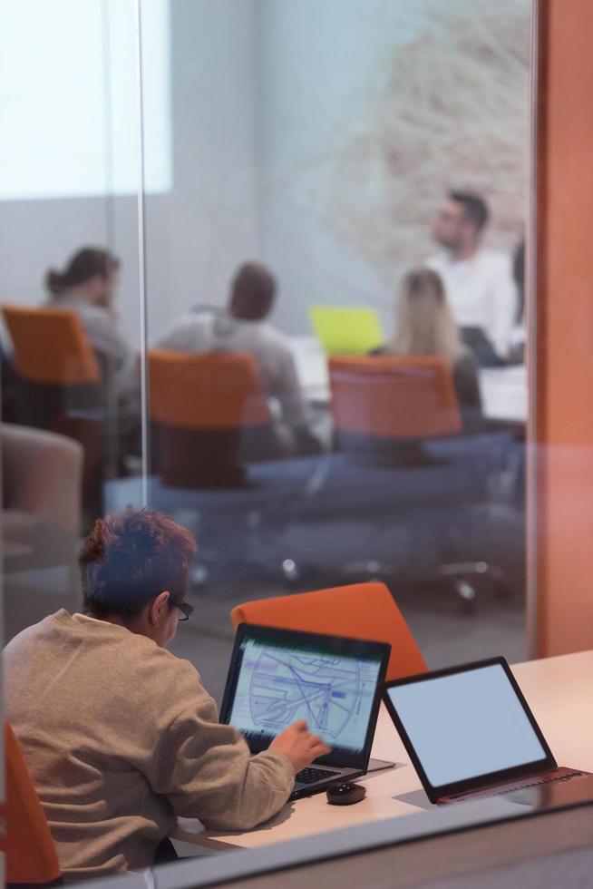 businesswoman using a laptop in startup office photo