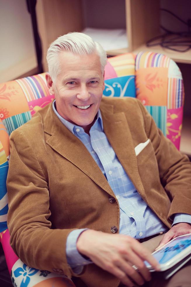 portrait of handsome teacher in colorful chair photo