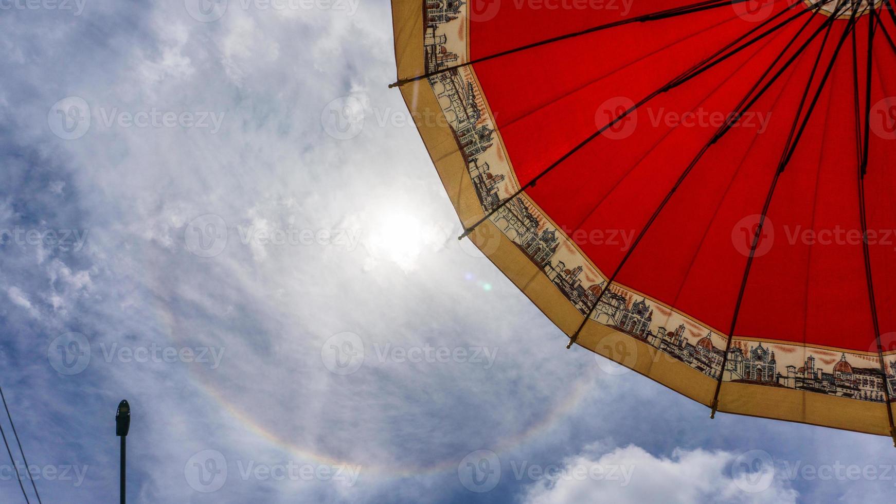 sun halo in the sky with umbrella photo