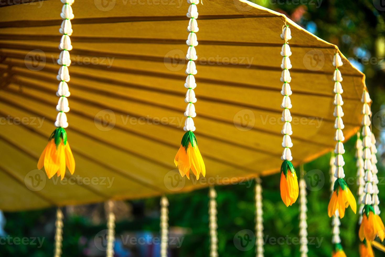 Wooden frame handmade umbrella with mulberry paper decorated with jasmine garland photo