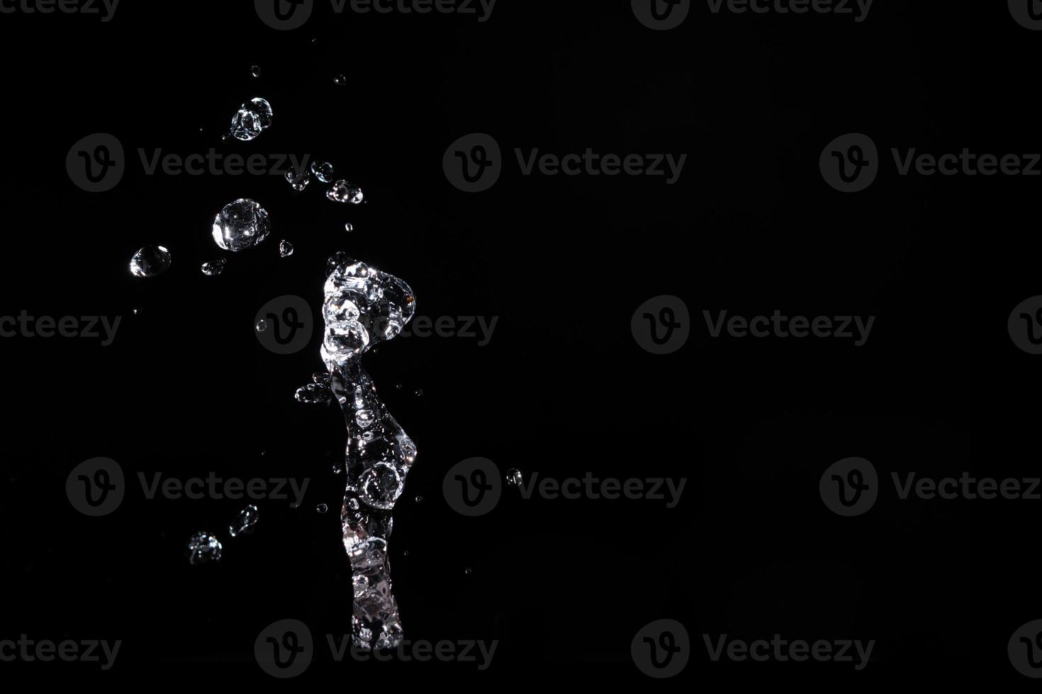 Water splash shot in studio, white water and black background, pure water for drink and food concept copy space for text and design photo