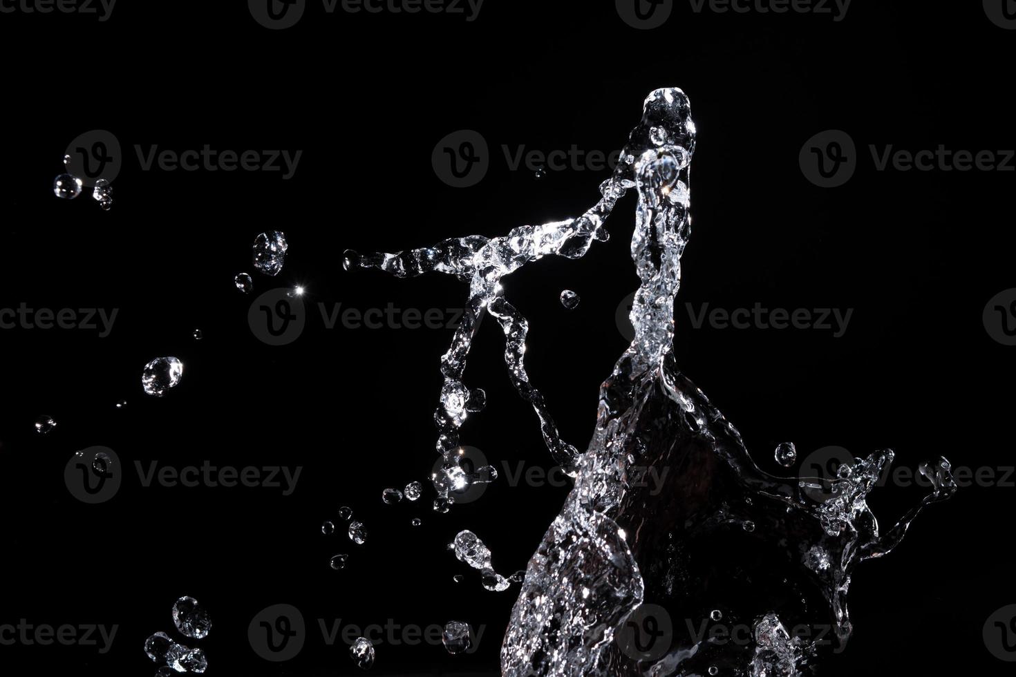 Water splash shot in studio, white water and black background, pure water for drink and food concept copy space for text and design photo