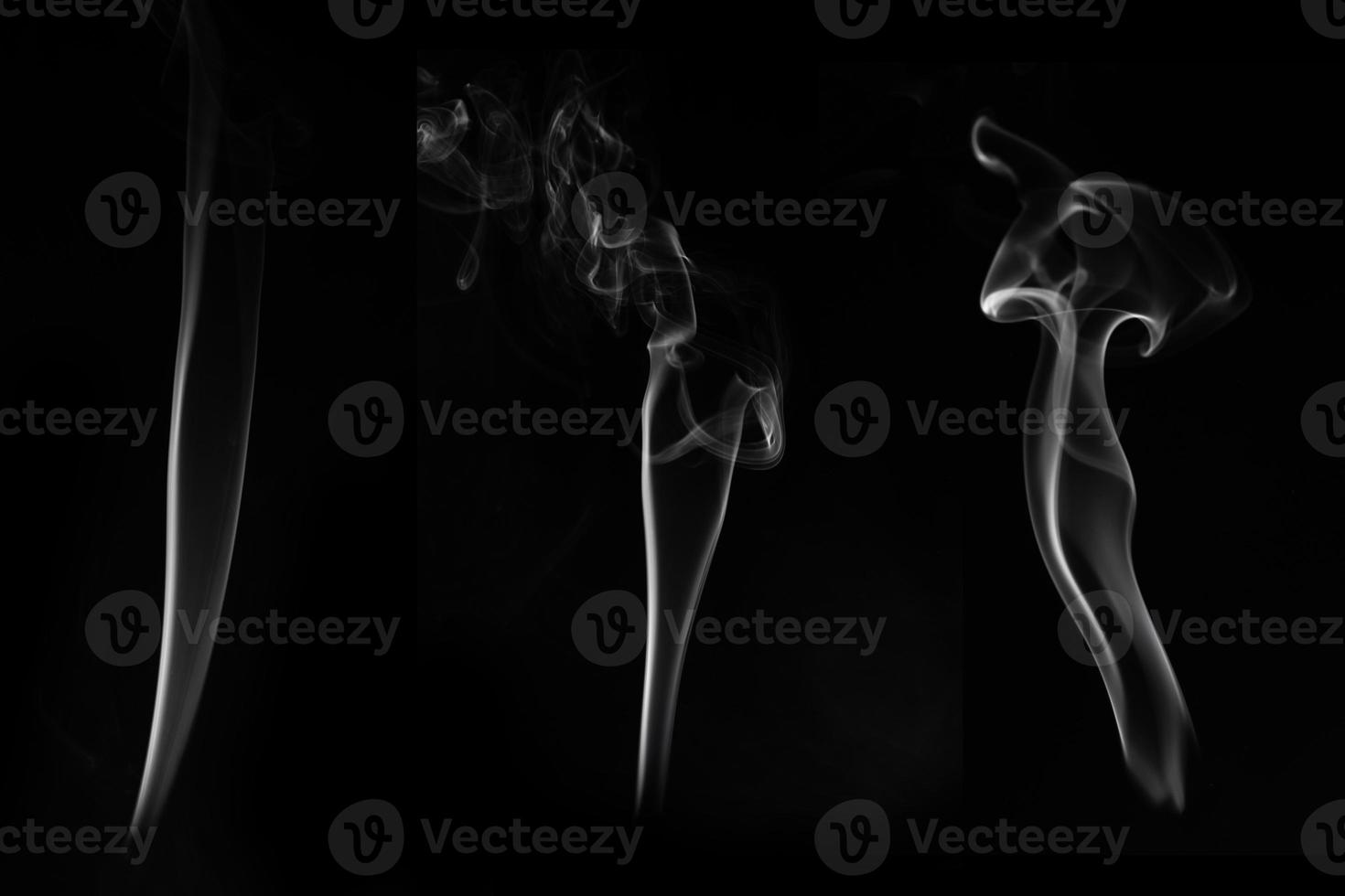 three white smoke burn from incense, shot in studio with dark black background, for design and religion concept photo