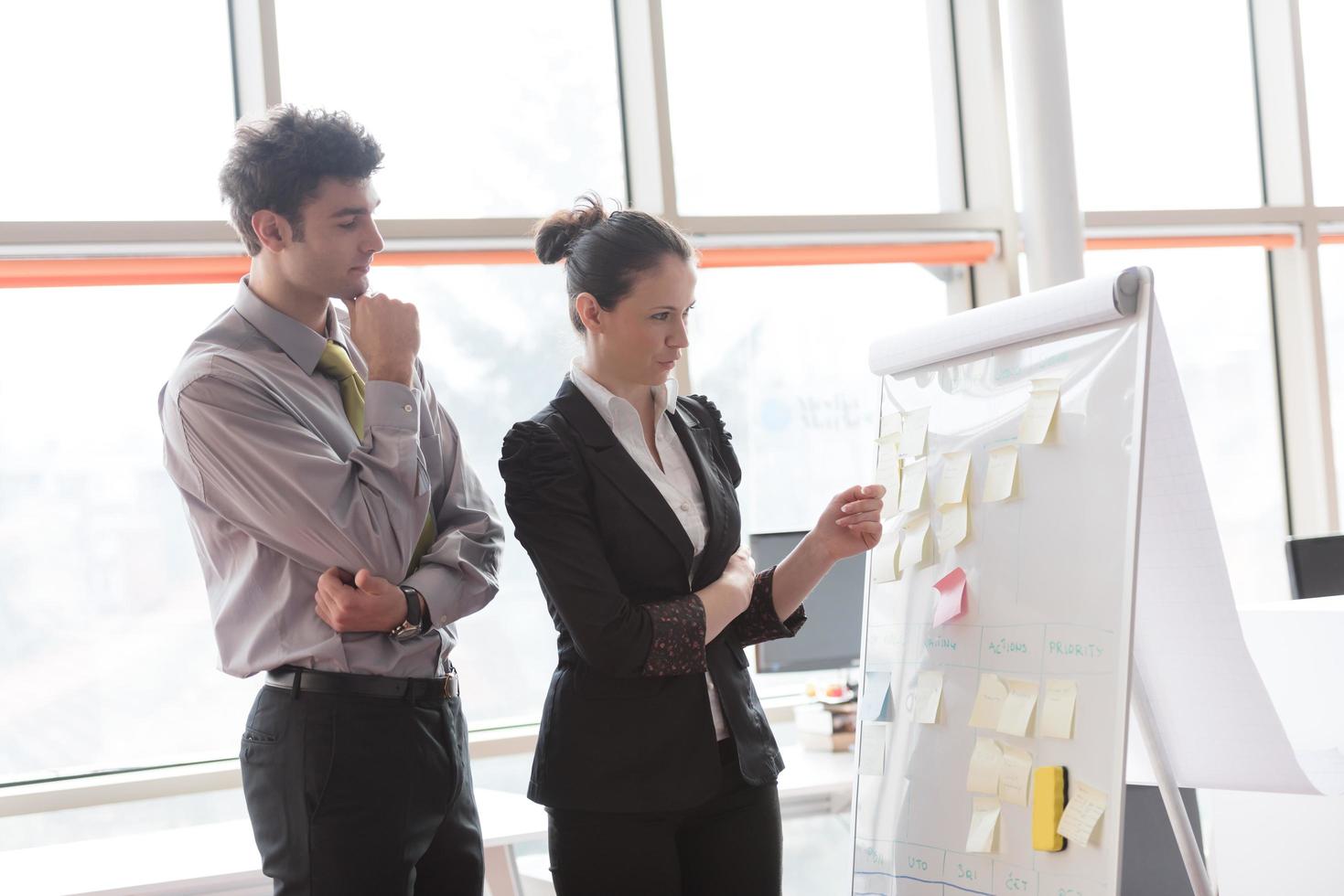 young couple working on flip board at office photo