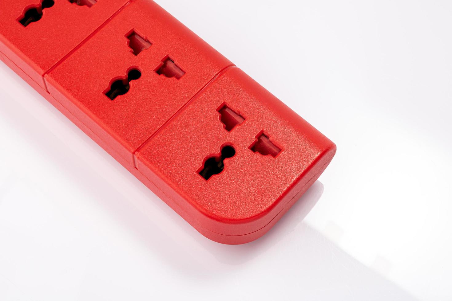 Multi-channel power plug, red on a white background. photo