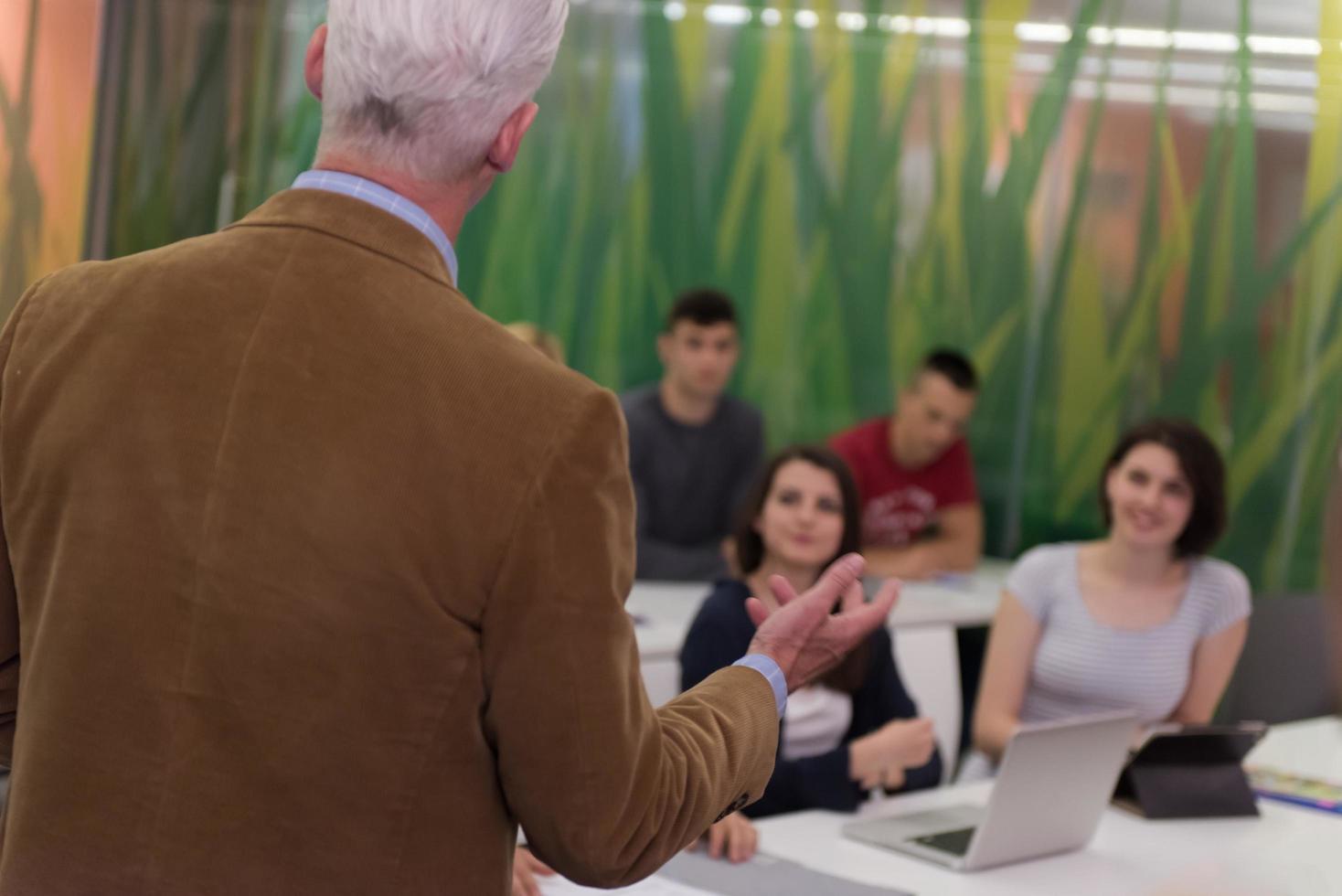 teacher with a group of students in classroom photo