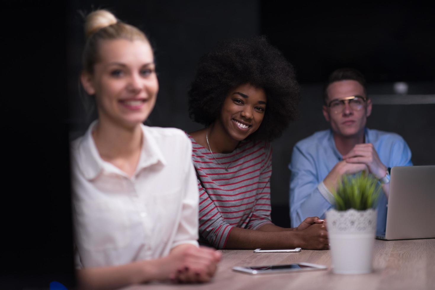 Multiethnic startup business team in night office photo