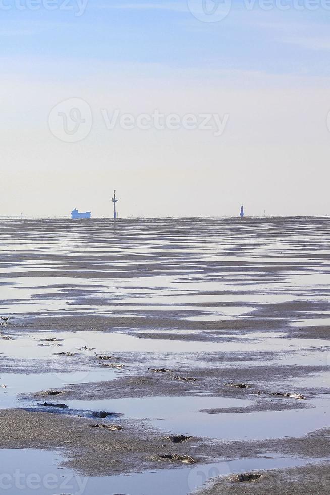 Seascape beach mudflats hiking on the North Sea coast Germany. photo