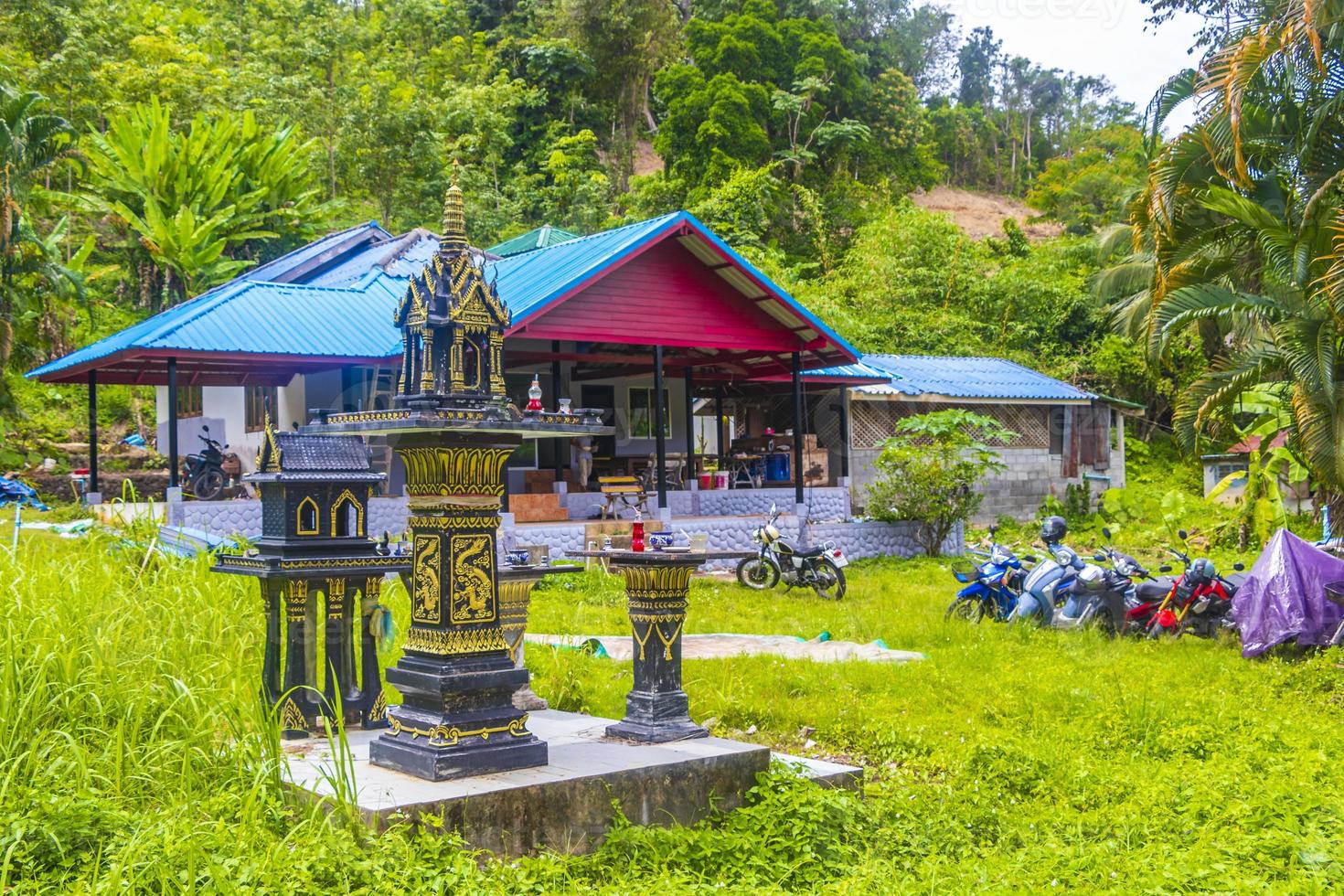 Holy ghost house shrine small temple garden yard village Thailand. photo