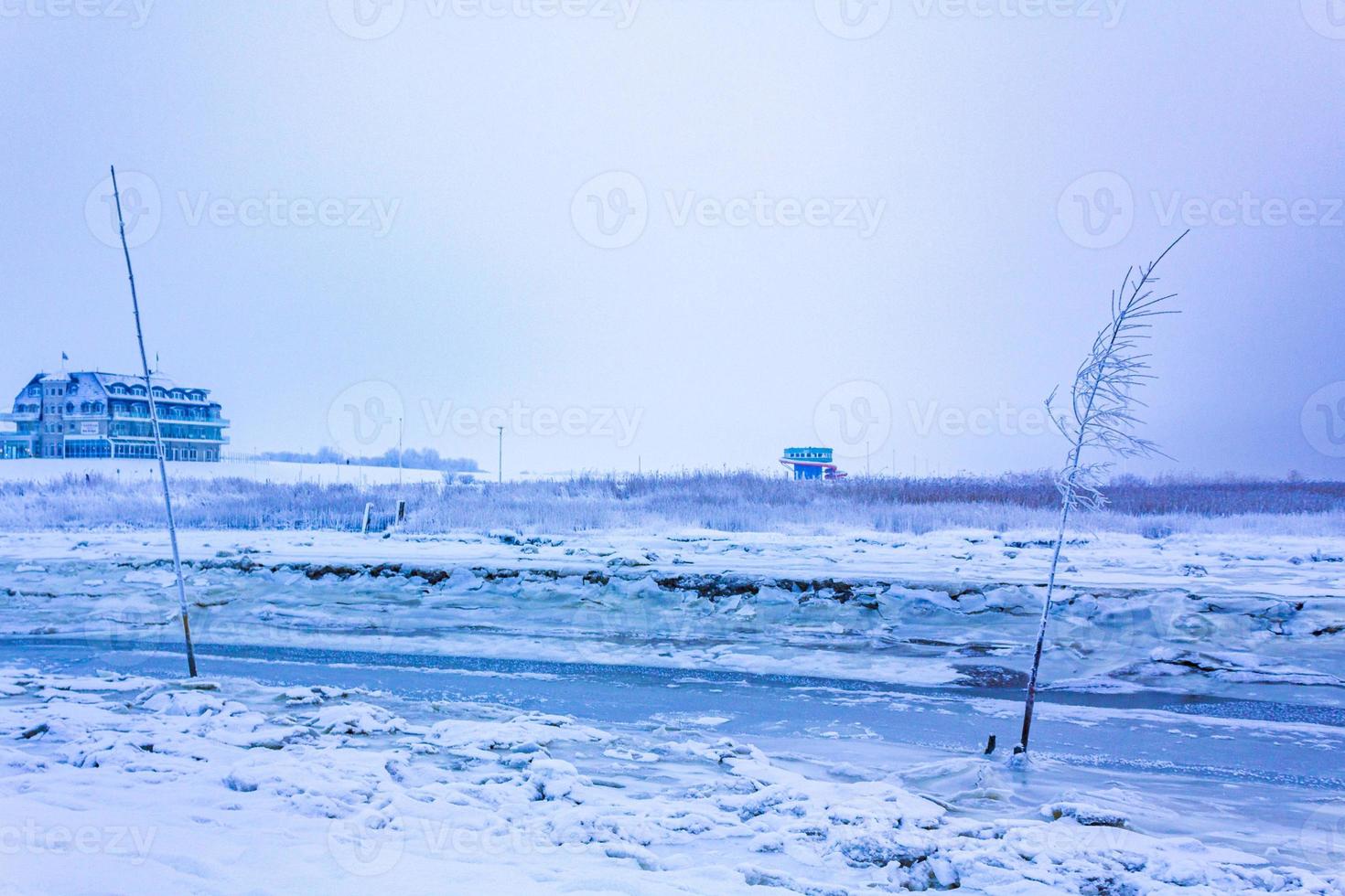 Frozen river sea on dike snow ice floes glate ice. photo
