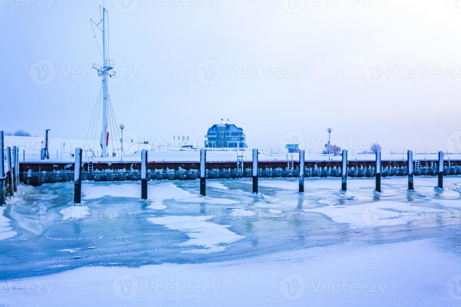 Frozen river sea on dike snow ice floes glate ice. photo