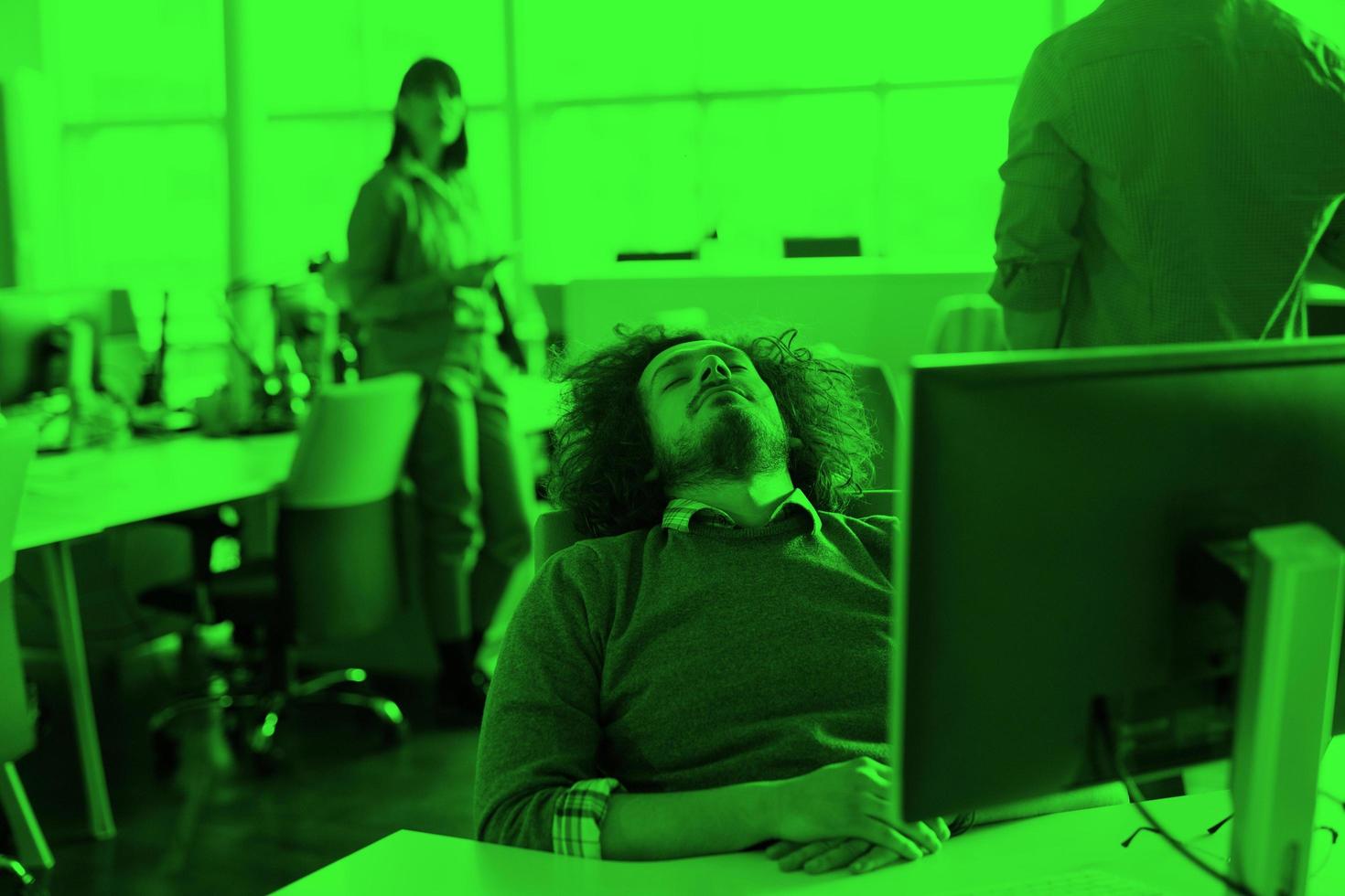 young businessman relaxing at the desk photo