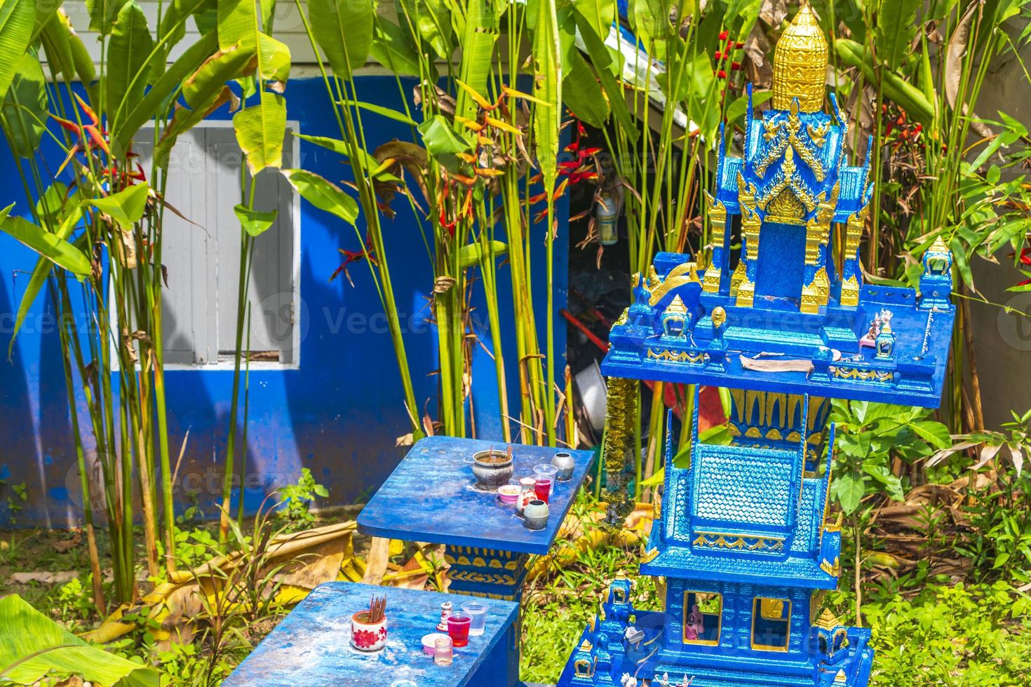 Holy ghost house shrine small temple garden yard village Thailand. photo