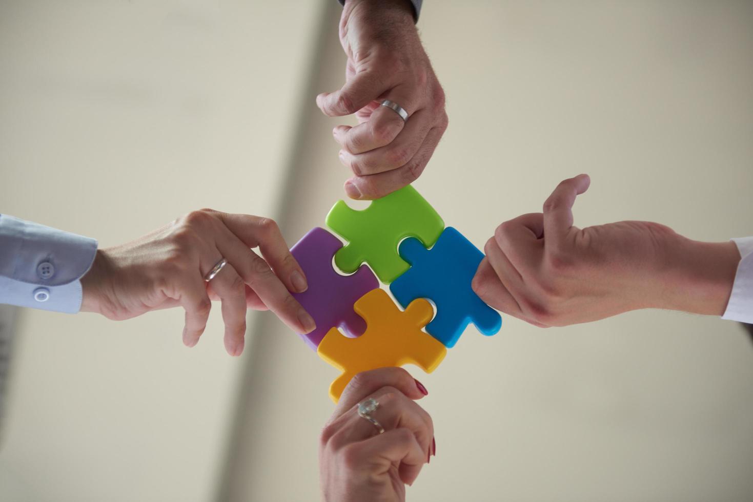 business people group assembling jigsaw puzzle photo