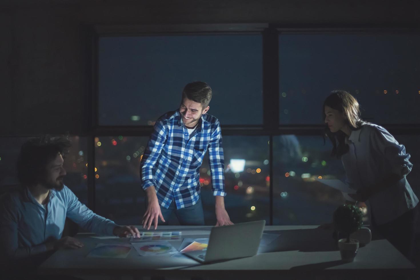 business people on construction site  in new startup office at night photo