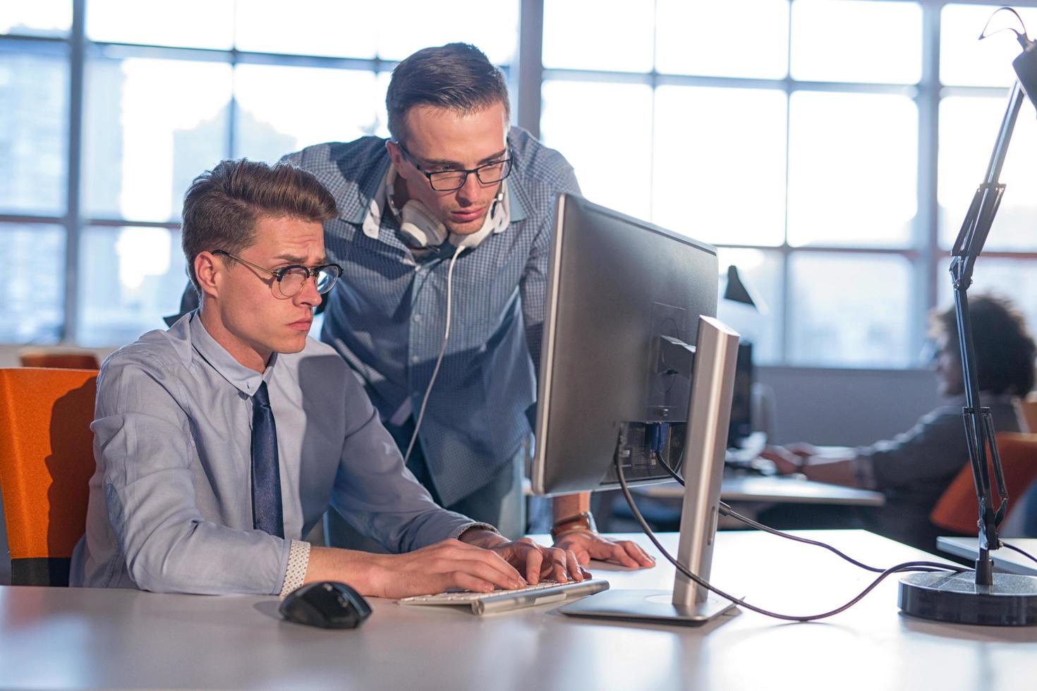 Two Business People Working With computer in office photo