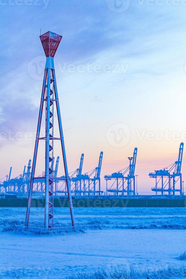 Shipyard cranes shipyard crane sunset winter container port Bremerhaven Germany. photo