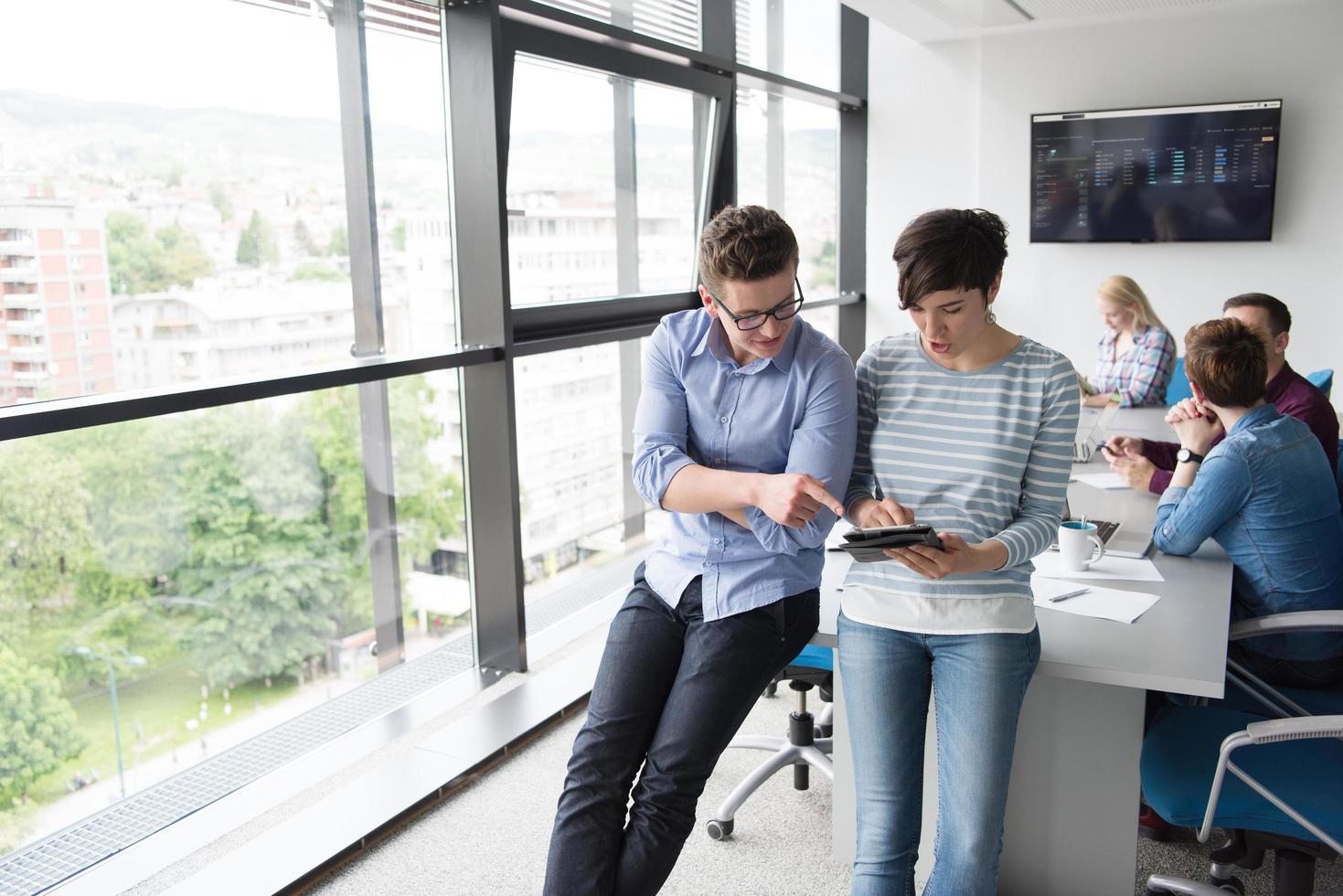 Two Business People Working With Tablet in office photo