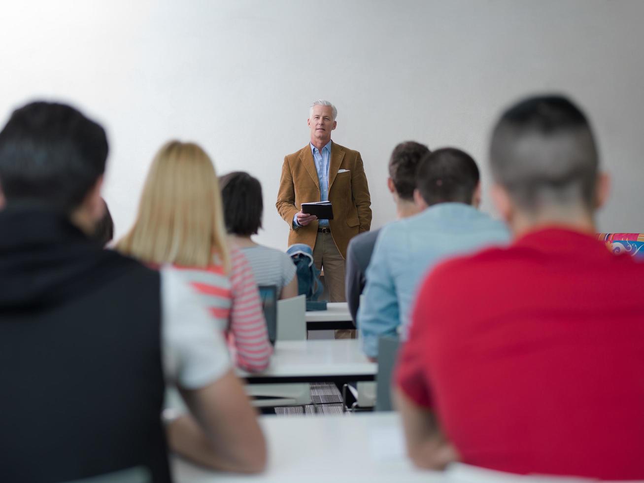 teacher with a group of students in classroom photo