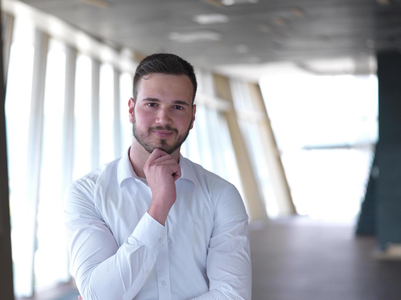 portrait of young  business man with beard at modern office photo