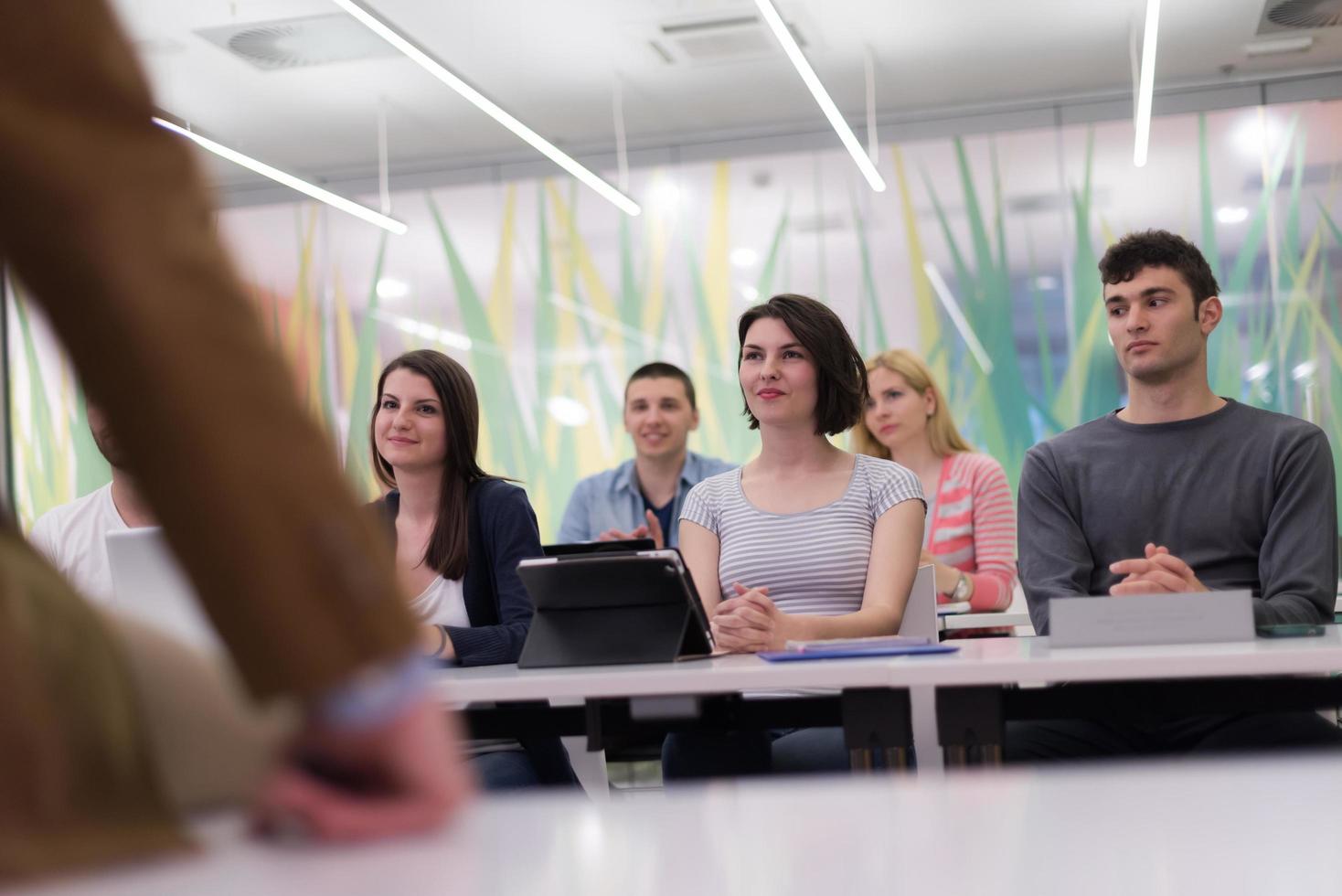 teacher with a group of students in classroom photo