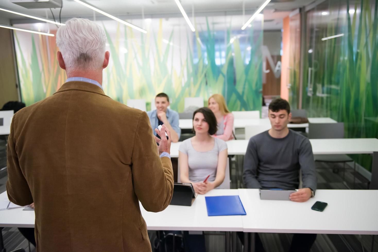 teacher with a group of students in classroom photo