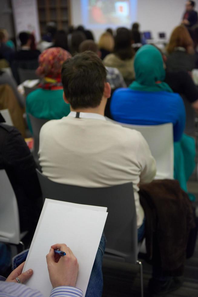 taking notes on business conference photo