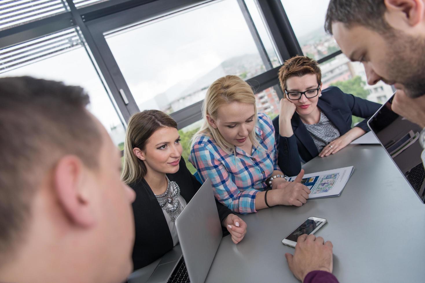 Group of young people meeting in startup office photo